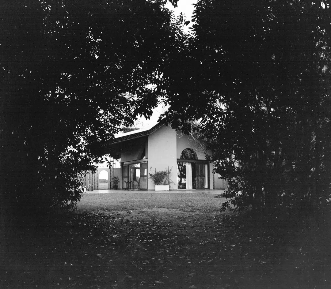 Archive photograph of the house seen through the trees