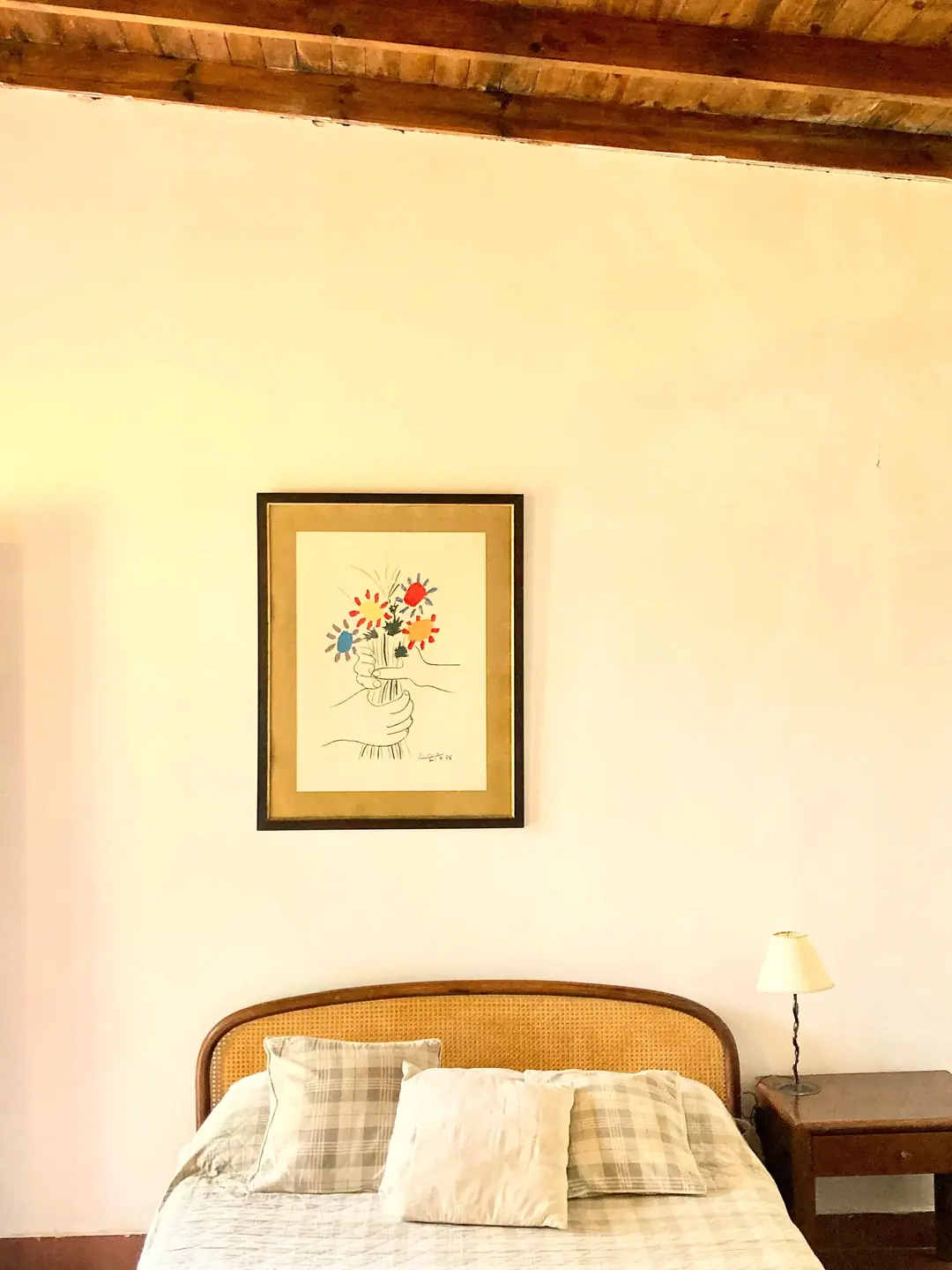 A bedroom with a simple timber ceiling
