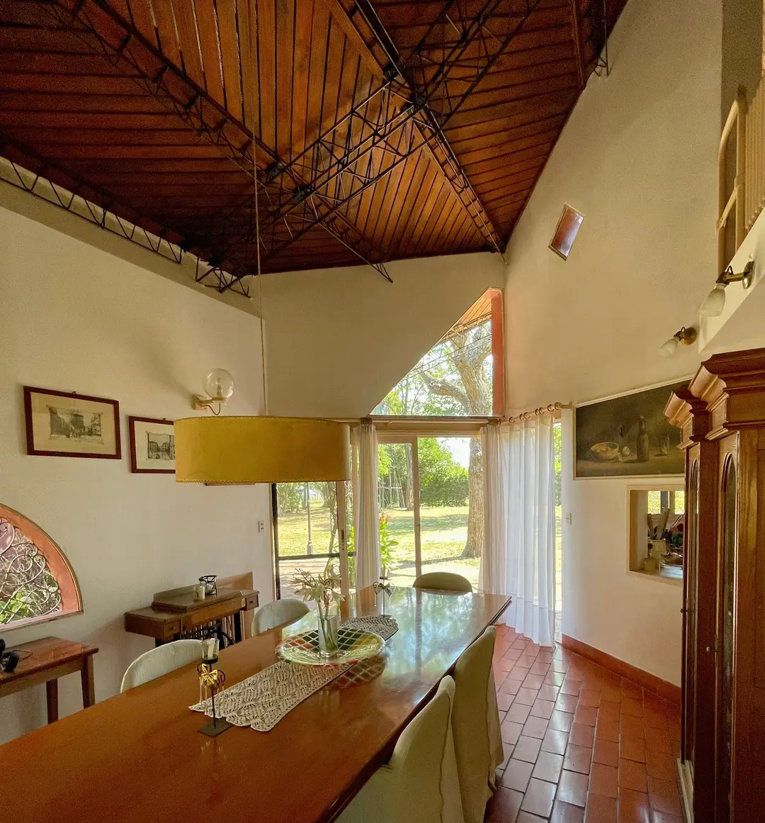 Dining table beneath the timber and steel ceiling