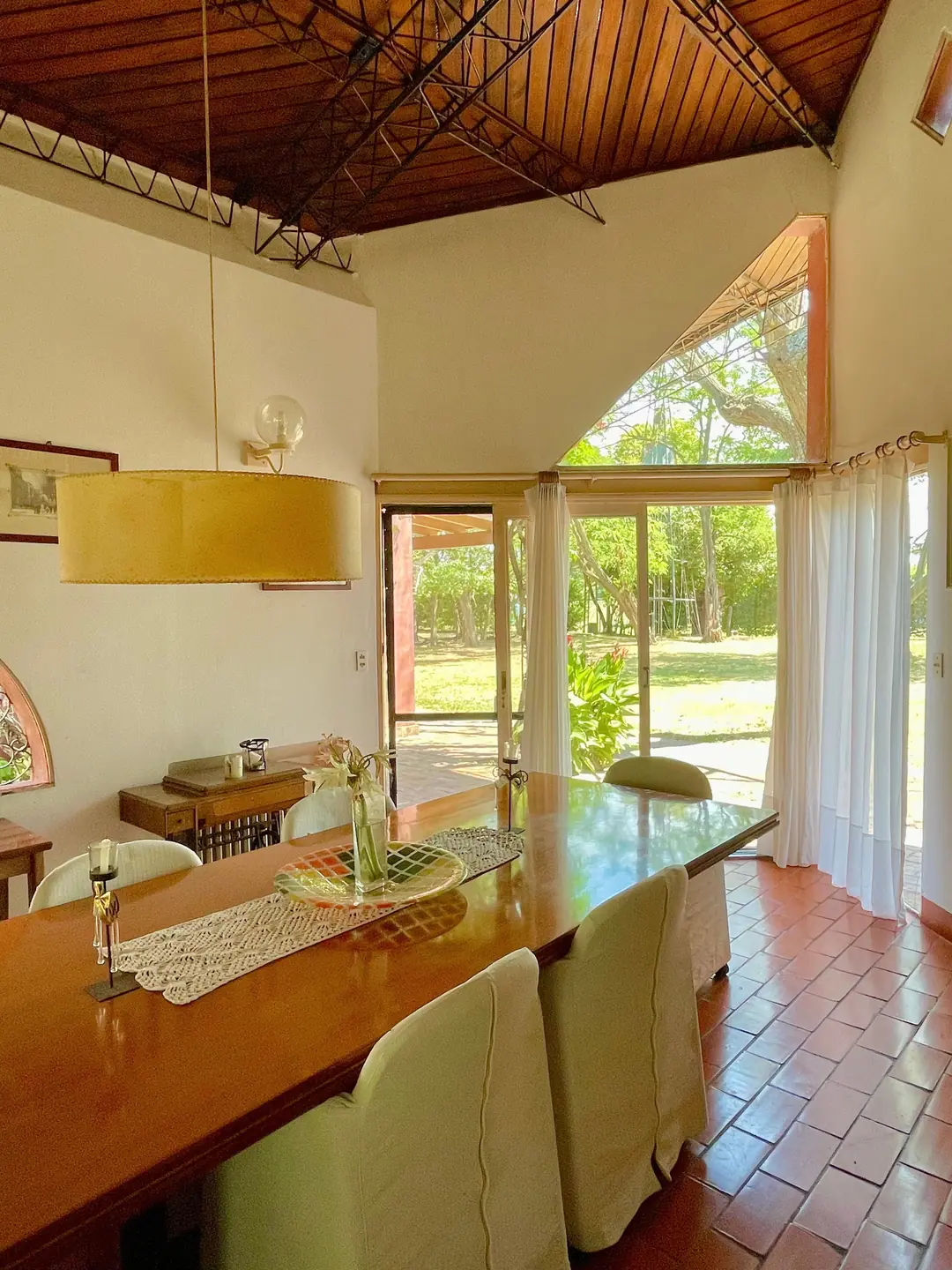 Dining table beneath the timber and steel ceiling