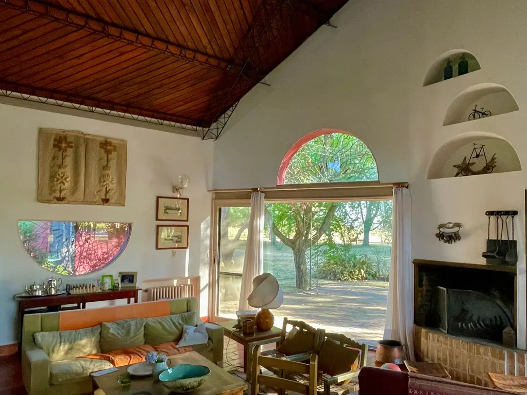 The double-height living room with fireplace and arched window