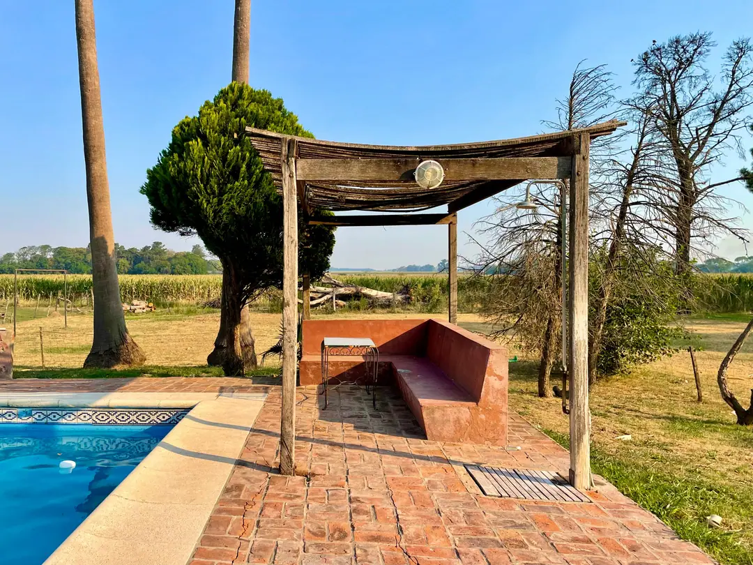 The pool with the pergola and masonry seating